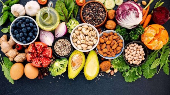 Assortment of natural detox foods including fruits, vegetables, nuts, seeds, and leafy greens.